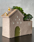 Stucco Desert Home With Cat Resting On Roof